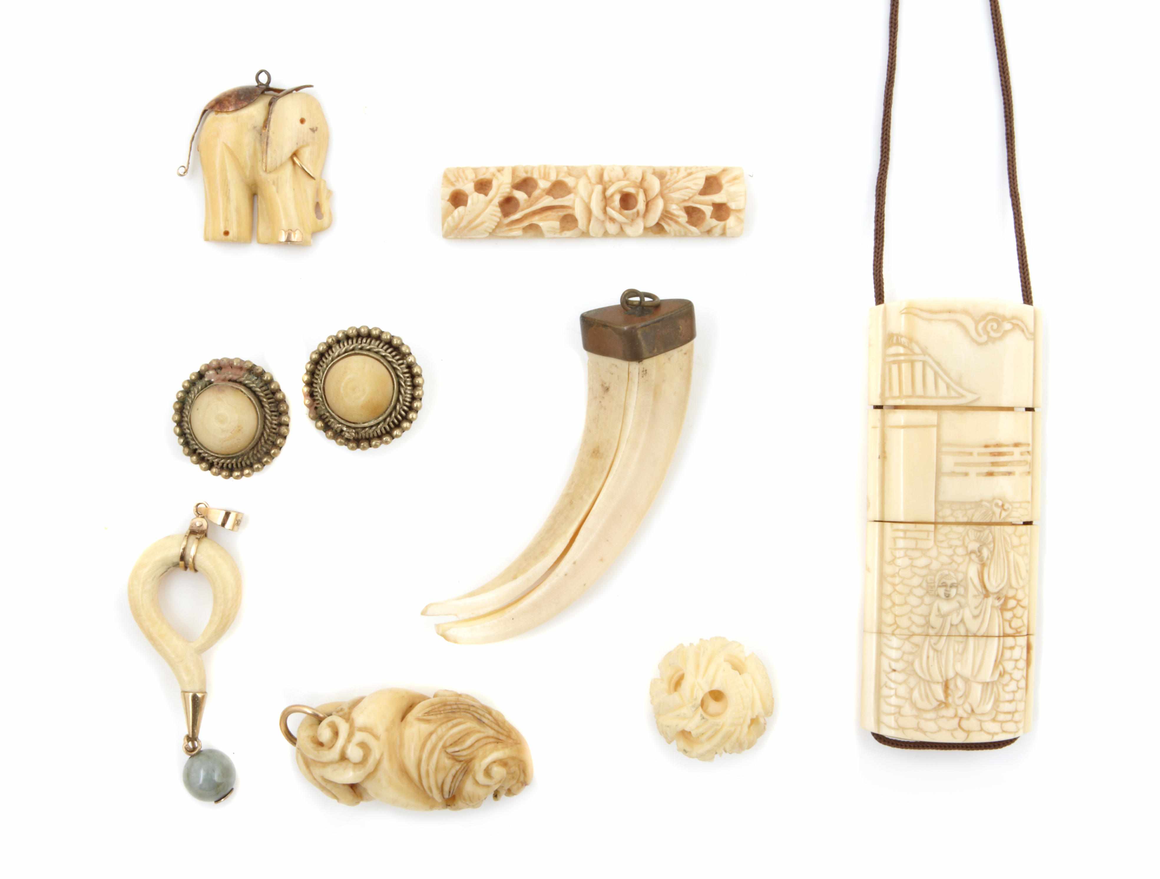 Appraisal: A collection of ivory bone and metal jewelry comprising pendants