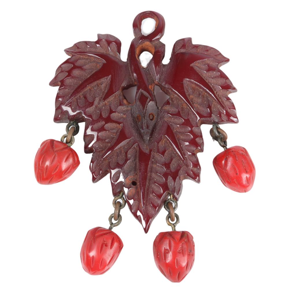 Appraisal: CARVED MAROON BAKELITE LEAF PIN WITH DANGLING RED BERRIES H