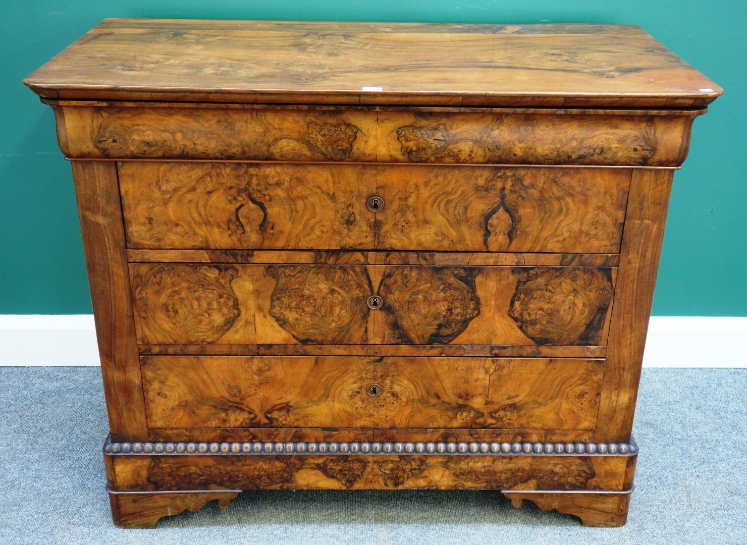 Appraisal: A th century French figured walnut chest of four long