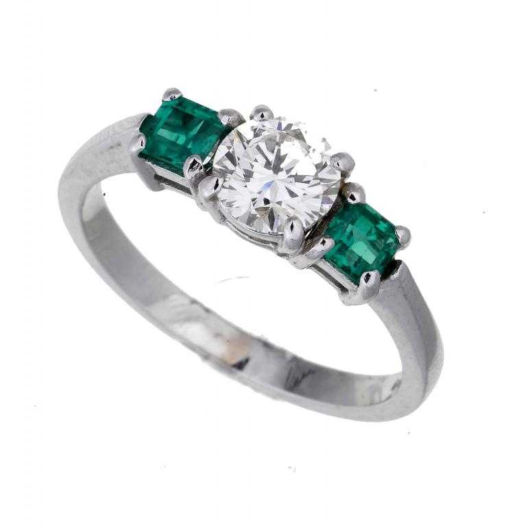 Appraisal: AN EMERALD AND DIAMOND THREE-STONE RING ct white gold hoop