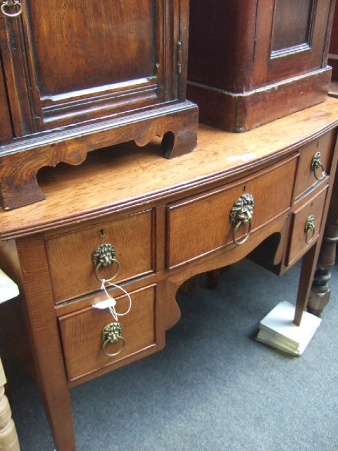 Appraisal: A late th century style mahogany bowfront sideboard with five