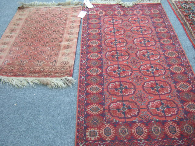 Appraisal: An Afghan rug the madder field with rows of stylized