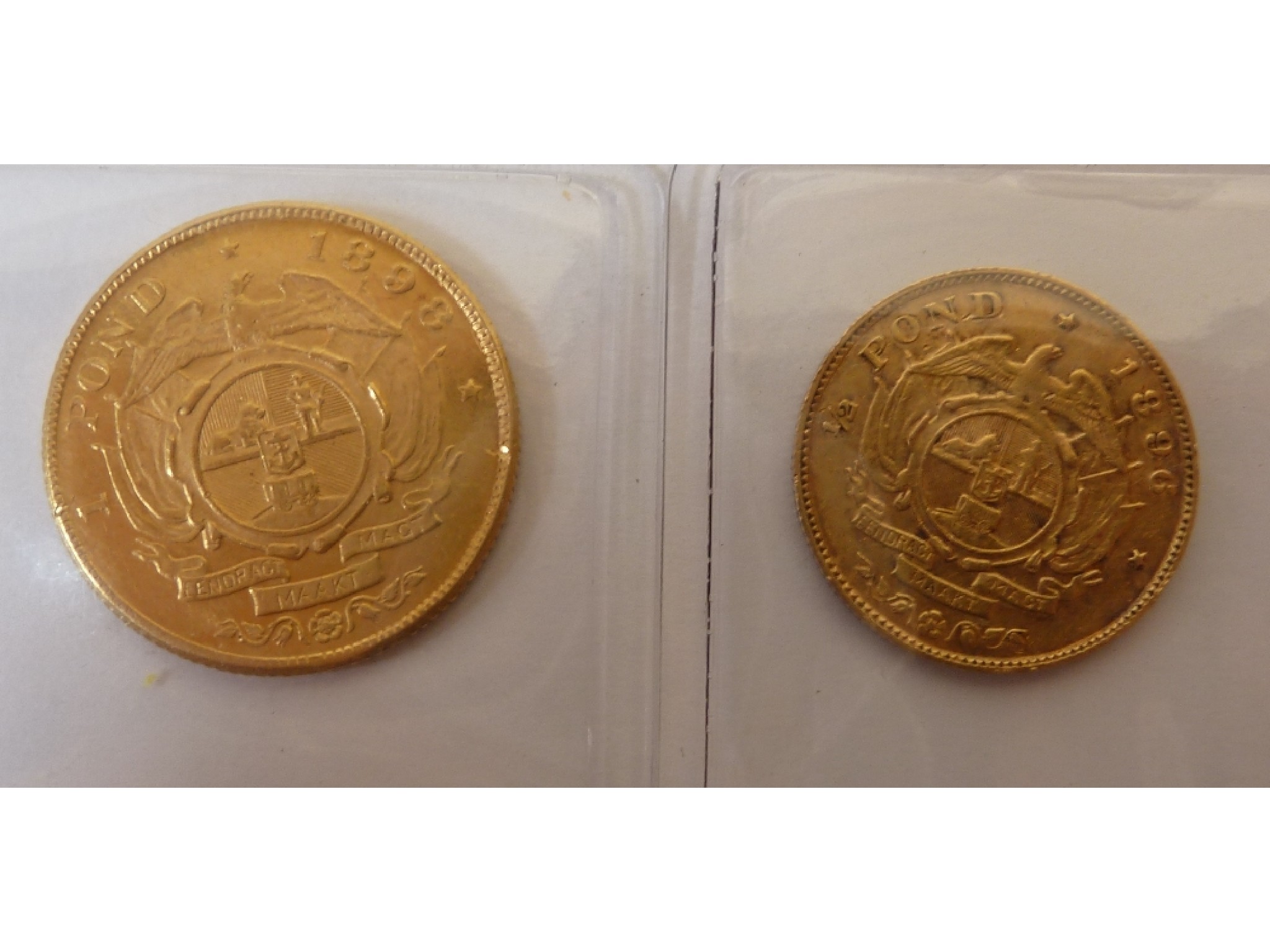 Appraisal: A SOUTH AFRICA POND GOLD COIN uncirculated together with a