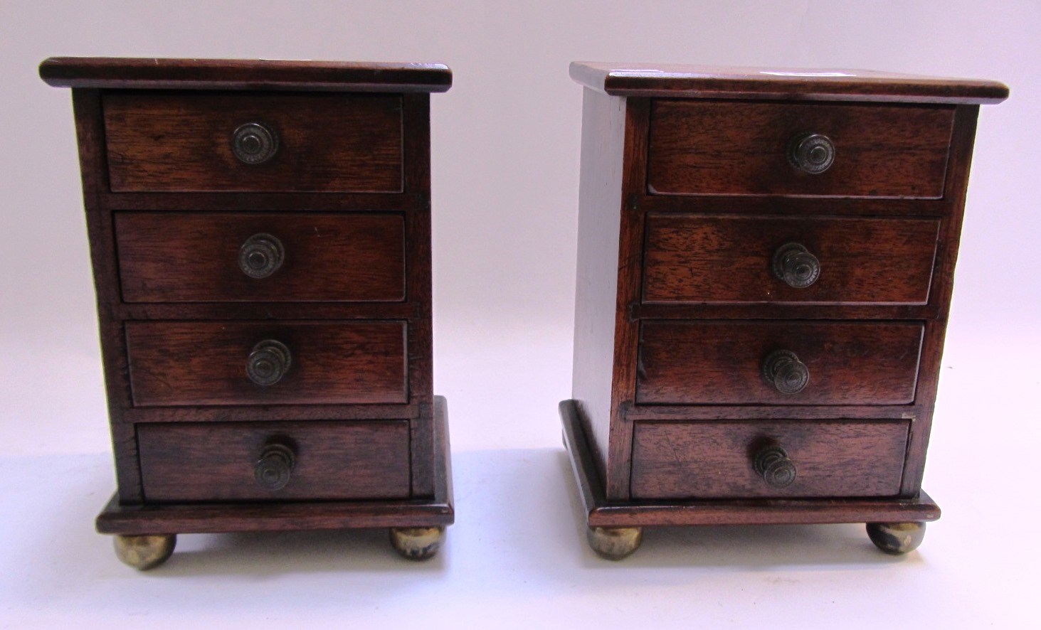 Appraisal: A pair of mahogany miniature four drawer pedestals on gilt