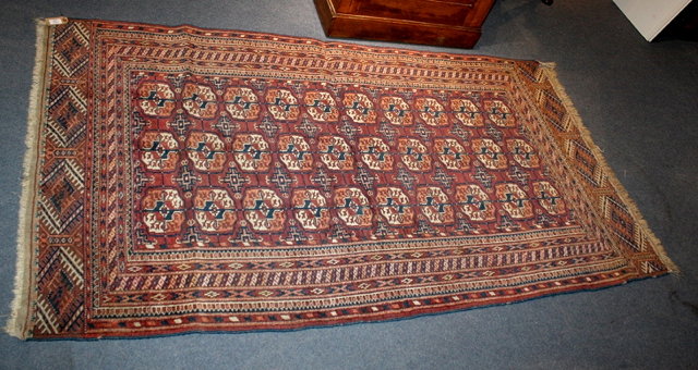 Appraisal: AN EASTERN RUG in Tekke style woven three rows of