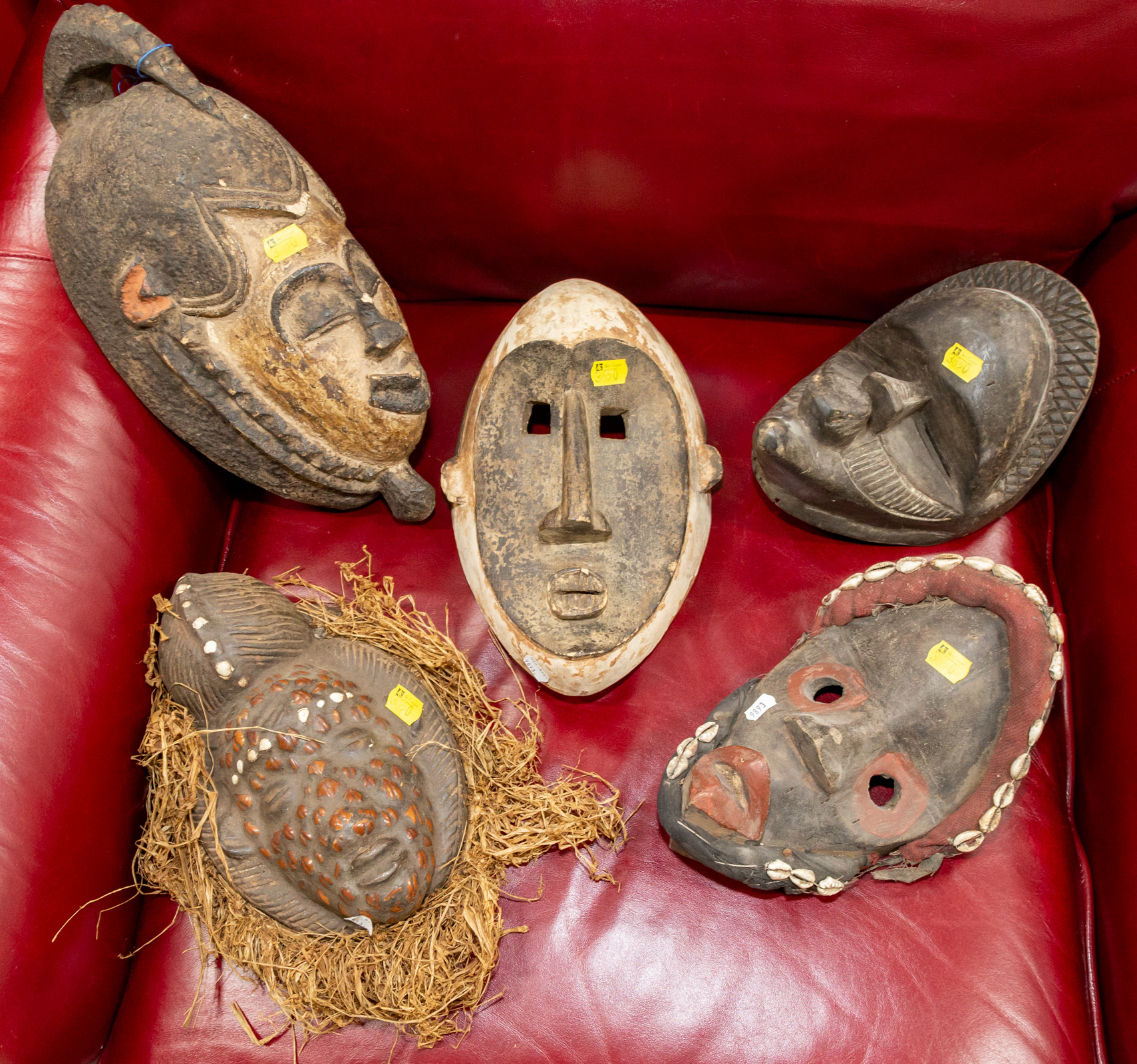 Appraisal: FIVE DECORATIVE AFRICAN CARVED WOOD MASKS Later th century including