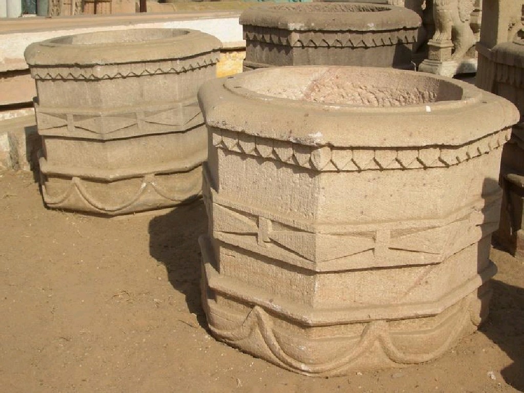 Appraisal: Pair of octagonal carved stone Urns with dentil frieze above