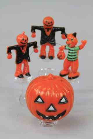 Appraisal: FOUR HARD PLASTIC HALLOWEEN DECORATIONS Includes cat holding jack-o-lantern Union