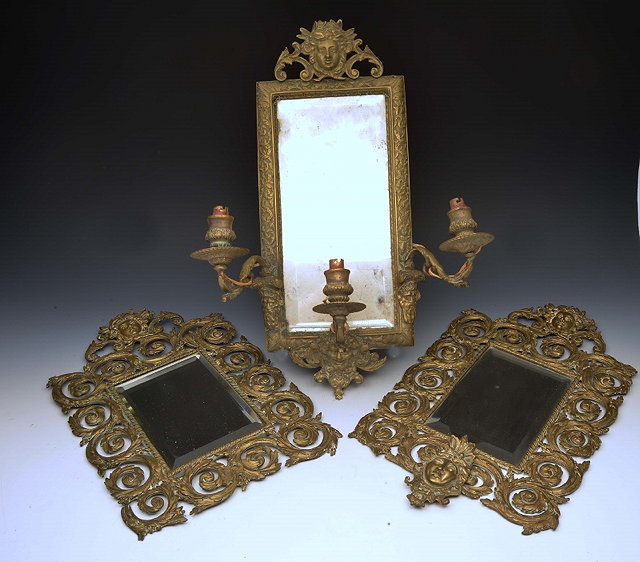 Appraisal: AN ITALIANATE EMBOSSED BRASS GIRANDOLE three branch with mask mounts