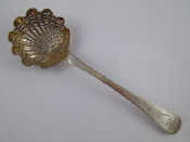 Appraisal: A French silver grade sifter ladle with finely pierced shell