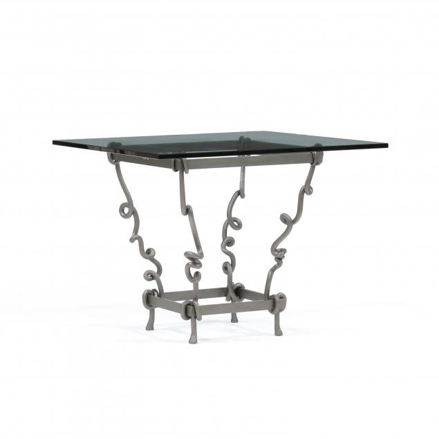 Appraisal: POST-MODERN SCULPTED STEEL AND GLASS TABLE Late th century thick