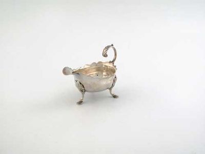 Appraisal: A George II small cream boat on three stepped leaf