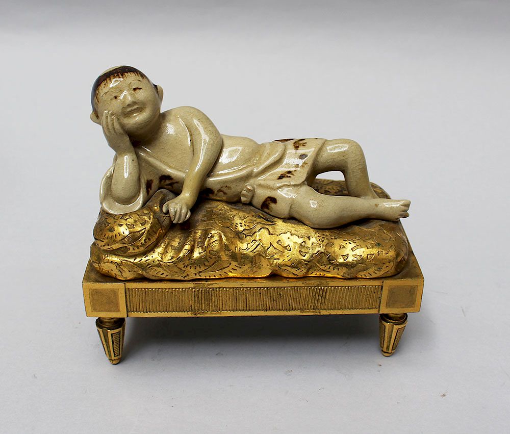 Appraisal: Chinese French Sculpture Chinese French Sculpture of a reclining boy