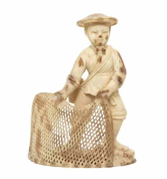 Appraisal: A Carved Ivory Figure depicting a fisherman holding a pierce