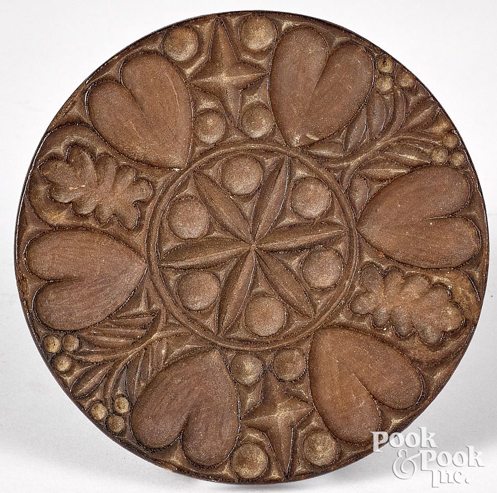 Appraisal: Intricately carved mahogany butterprint Intricately carved mahogany heart and pinwheel