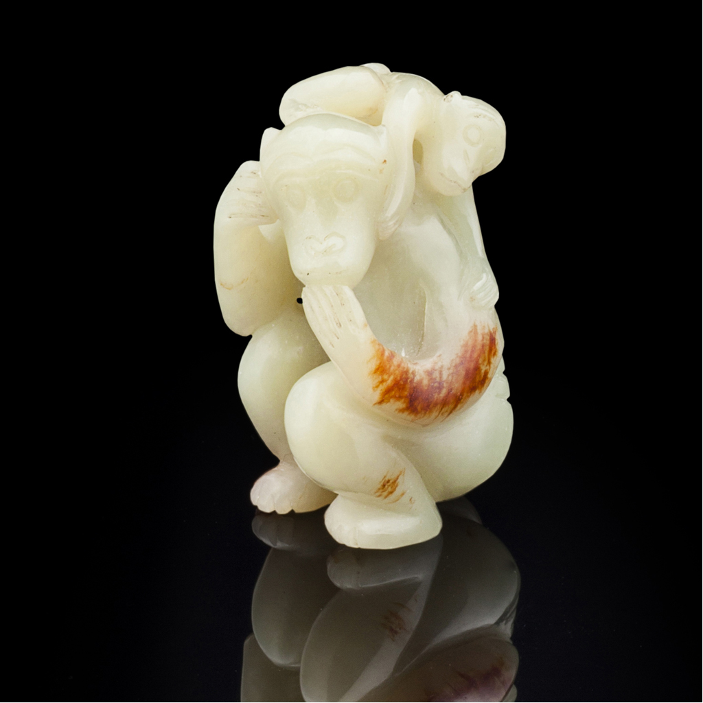 Appraisal: CELADON JADE FIGURE GROUP with russet inclusions decpicting a seated