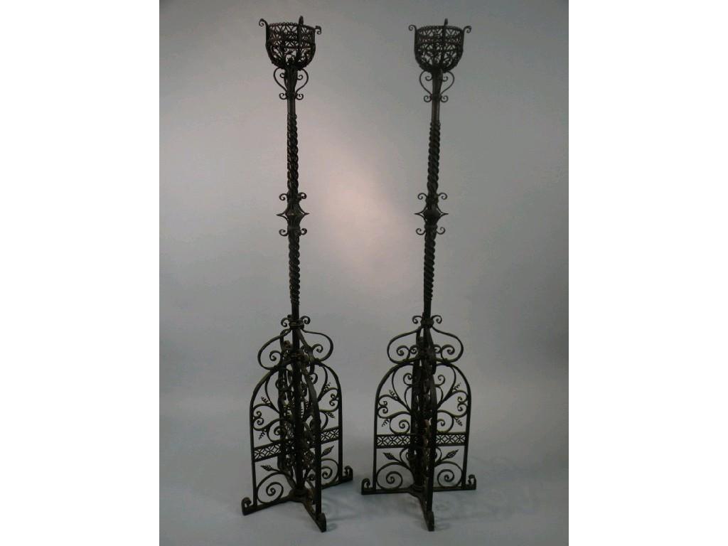 Appraisal: A pair of wrought iron candle stands each with spiral