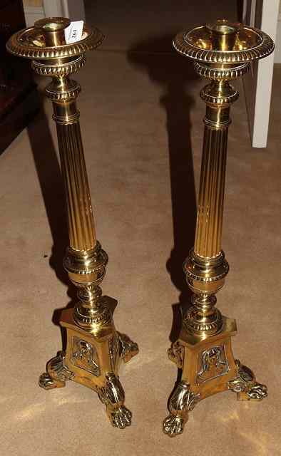 Appraisal: A PAIR OF BRASS ECCLESIASTICAL LARGE CANDLESTICKS with gadrooned vase