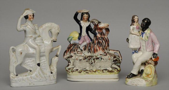 Appraisal: THREE STAFFORDSHIRE FIGURES Including Uncle Tom and Eva a mounted