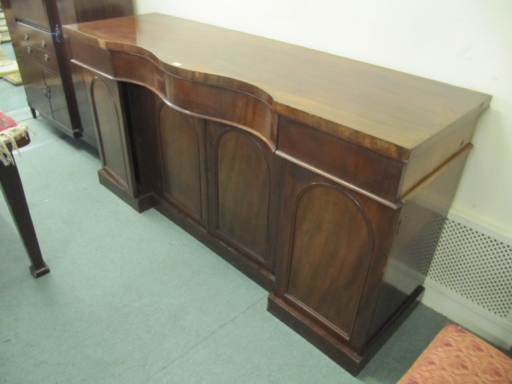 Appraisal: Victorian mahogany sideboard with a serpentine top over a breakfront