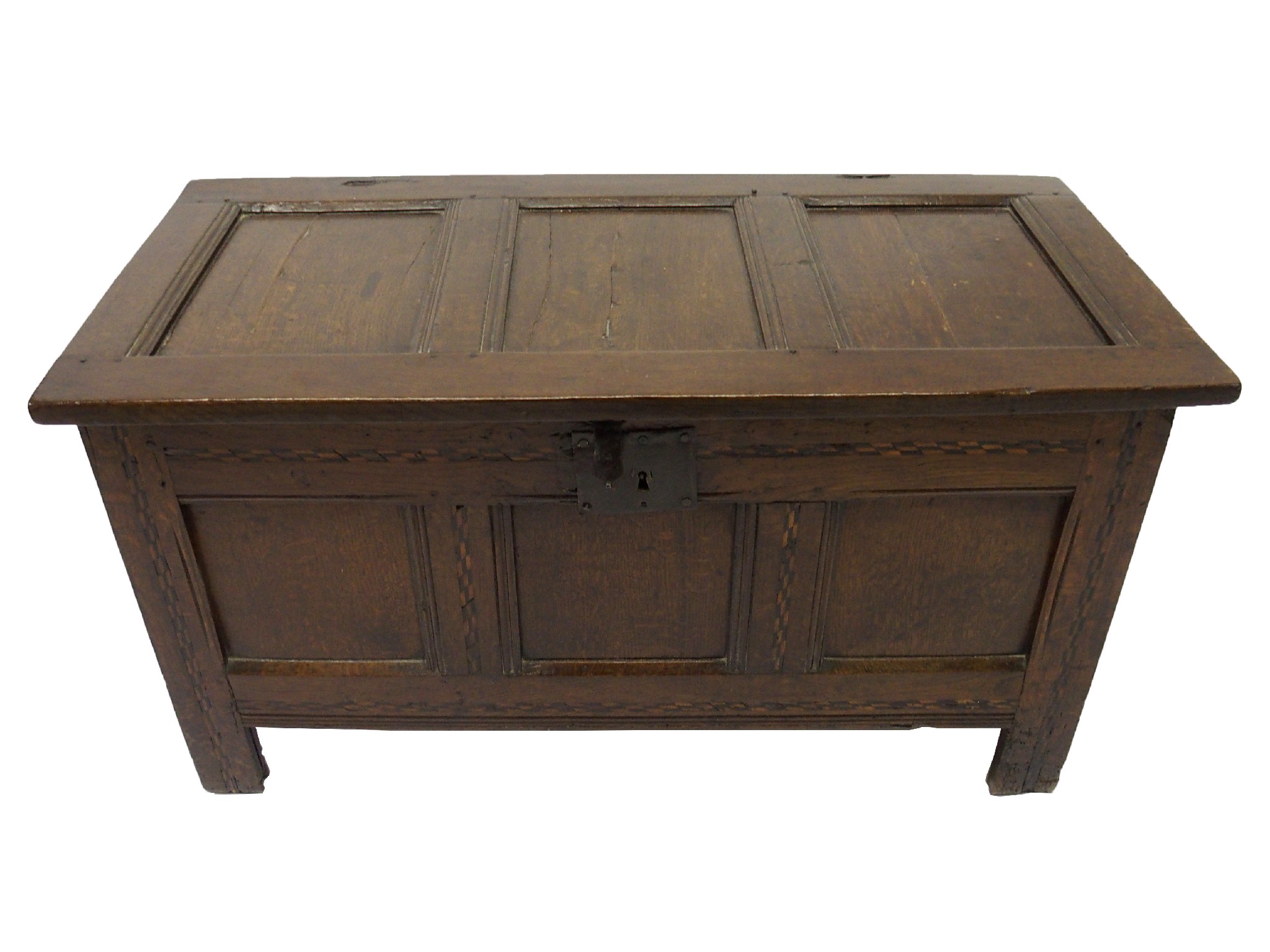 Appraisal: An oak cofferwith three panelled hinged top above panelled sides