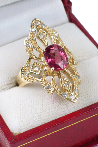 Appraisal: PINK SAPPHIRE DIAMOND AND FOURTEEN KARAT GOLD RING centering an