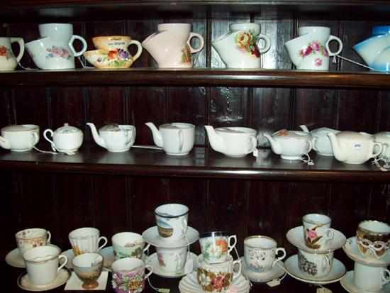 Appraisal: THREE SHELVES OF VICTORIAN CUPS CONSISTING OF MOUSTACHE CUPS INVALID