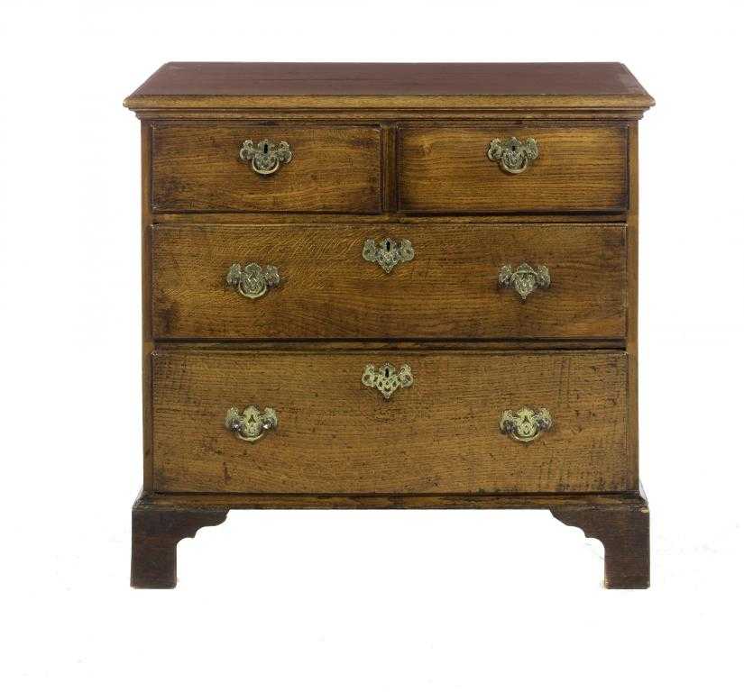 Appraisal: AN OAK CHEST OF DRAWERS fitted two short and two