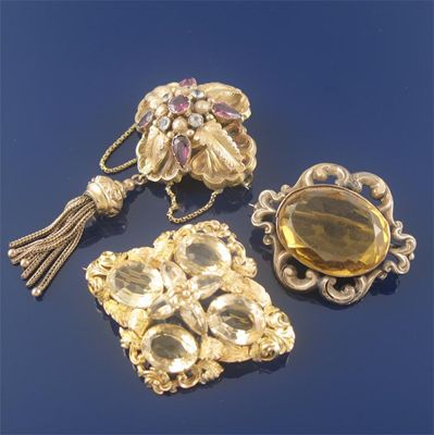 Appraisal: Three th century gold brooches a purple and white paste