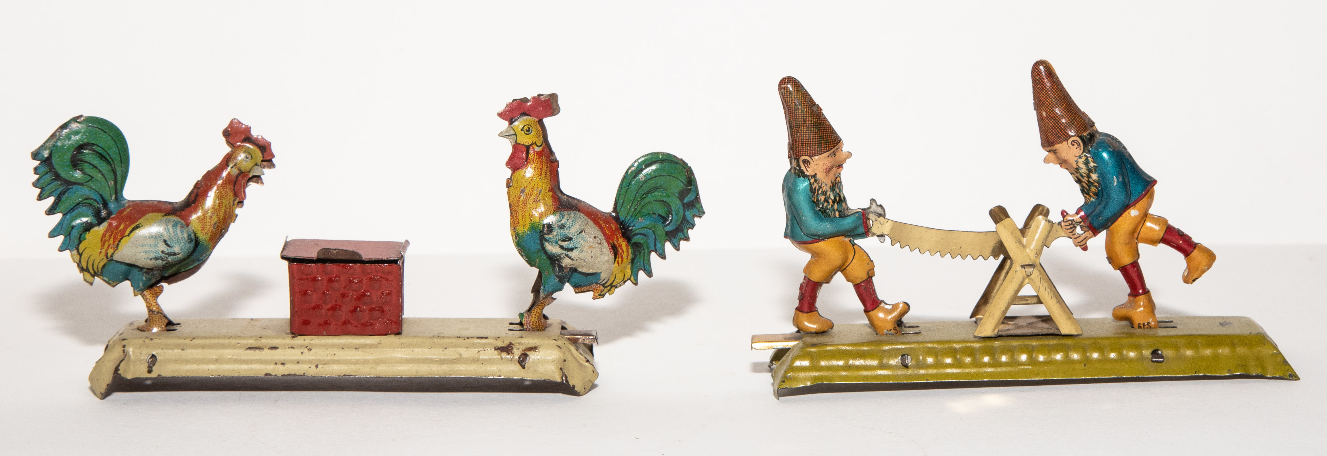 Appraisal: TWO GERMAN ACTION PENNY TOYS Early th century Includes gnomes