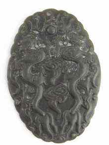 Appraisal: A Chinese black hardstone oval pendant with dragons and other