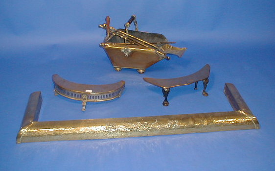 Appraisal: A Victorian brass coal scuttle tools fender and Tidy Betty's