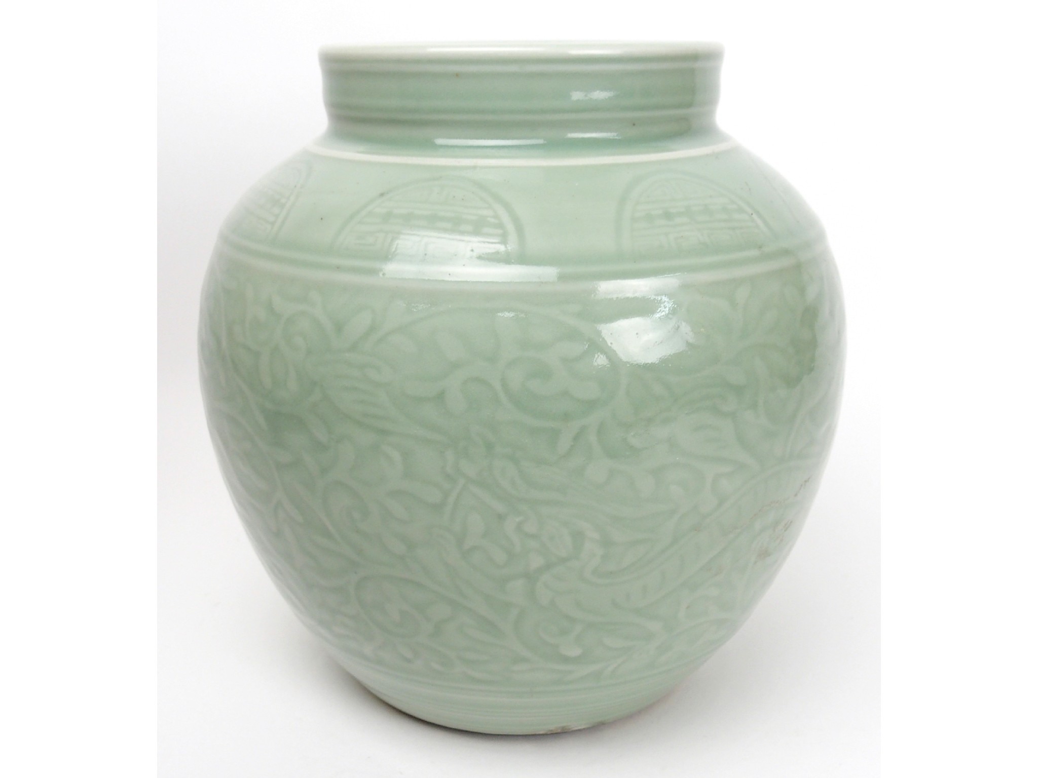 Appraisal: A Chinese Celadon ground vasecarved with dragons amongst scrolling foliage