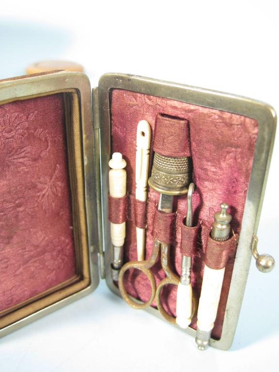 Appraisal: A leather Sewing Necessaire with concertina lid enclosing scissors thimble