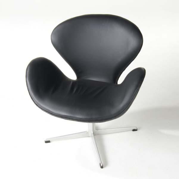 Appraisal: ARNE JACOBSEN Swan chair upholstered in black vinyl on steel