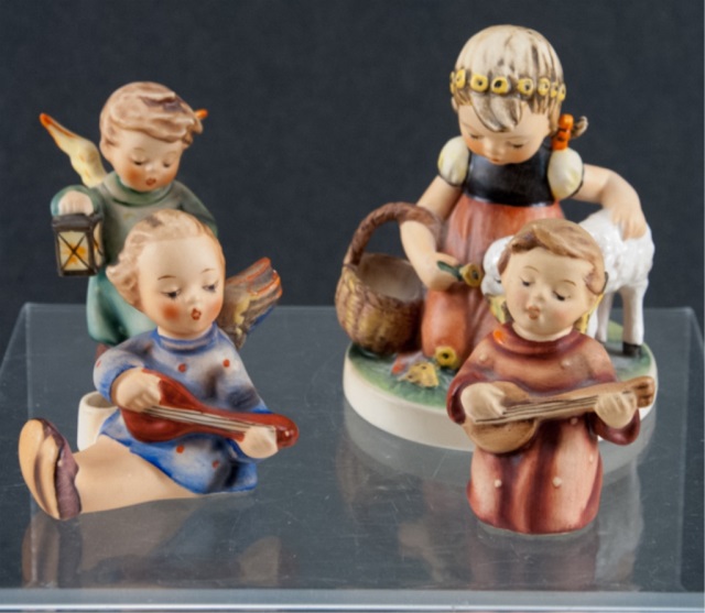 Appraisal: To include four Hummel figures Seated angel playing the banjo