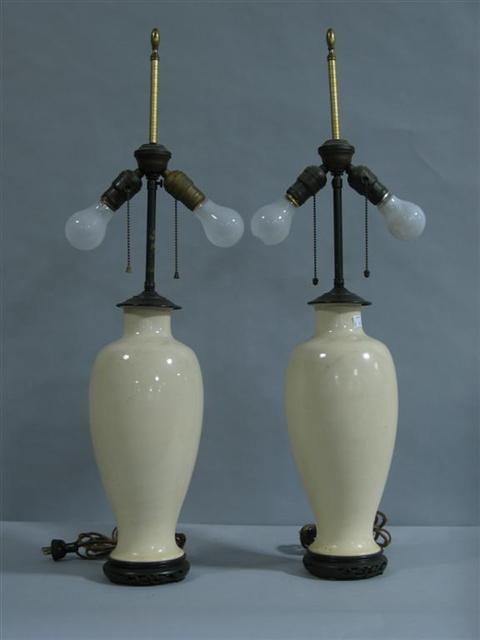 Appraisal: PAIR OF CHINESE CREAM CRACKLE GLAZED LAMPS The porcelain first