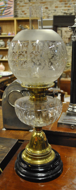 Appraisal: A Victorian oil lamp with etched shade cut glass font