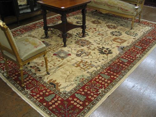 Appraisal: HAND KNOTTED ORIENTAL CARPET Serapi design of stylized flowers and