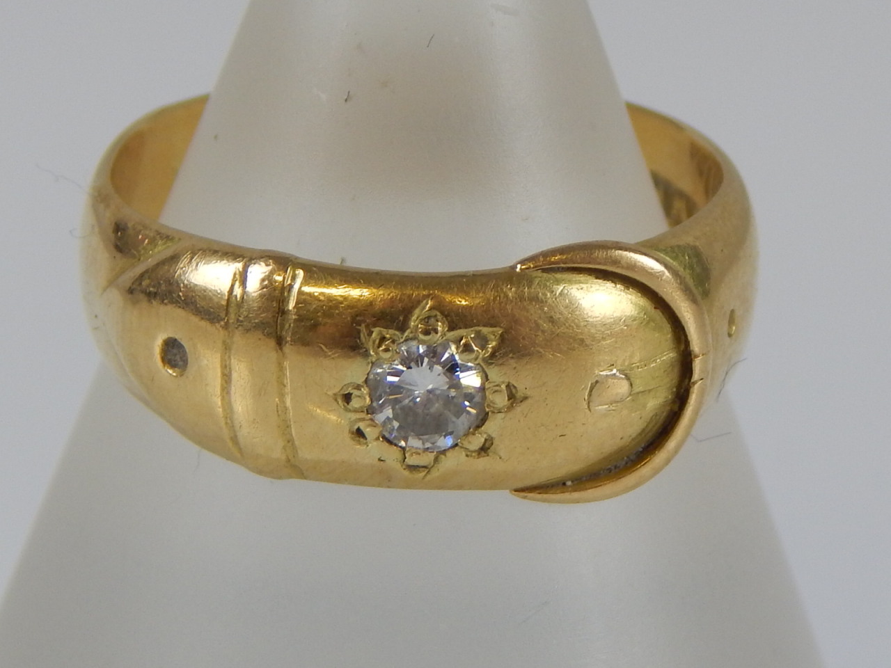 Appraisal: An ct gold buckle ring with inset diamond g all