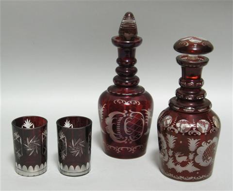 Appraisal: TWO BOHEMIAN GLASS DECANTERS The first of bottle form molded