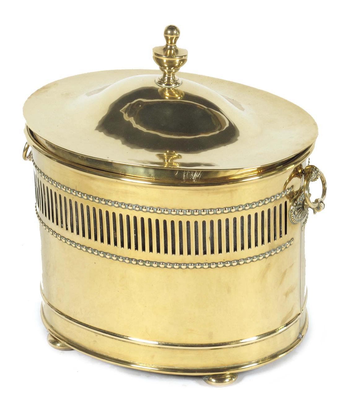 Appraisal: An Edwardian brass oval coal box and cover