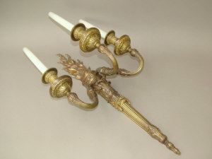 Appraisal: A pair of neo-classical style triple branch flaming torchere wall-lights