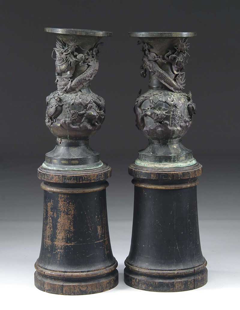 Appraisal: PAIR OF ORIENTAL BRONZE VASES ON WOOD STANDS The antique