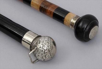 Appraisal: SILVER-HANDLED WALKING STICK AND A EBONY-HANDLED STICK The first spherical