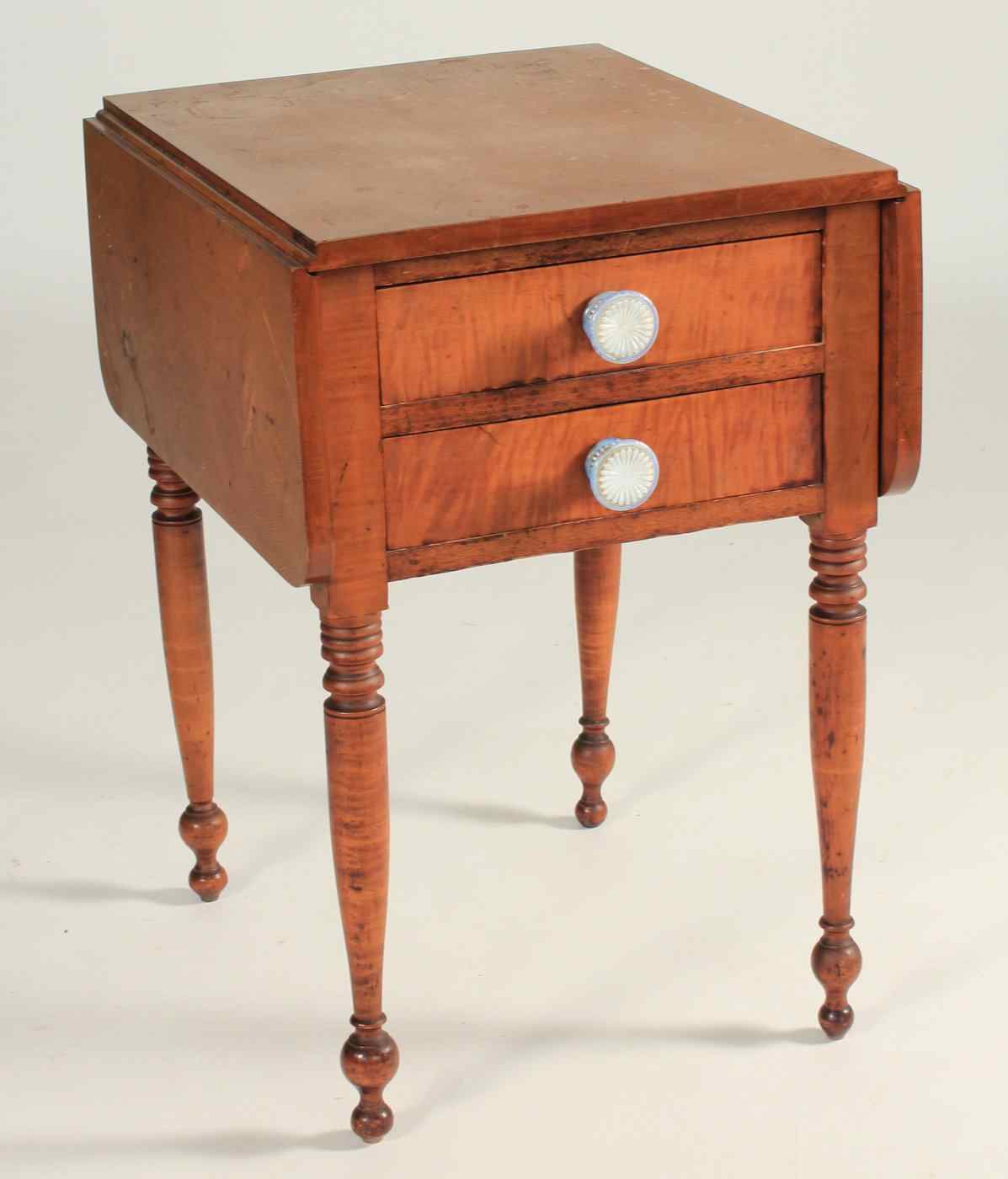 Appraisal: ANTIQUE AMERICAN TWO-DRAWER DROP-LEAF STAND th CenturyIn maple and tiger