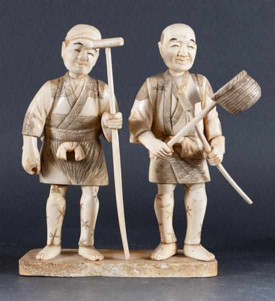 Appraisal: Japanese carved ivory figural group of two laborers th century