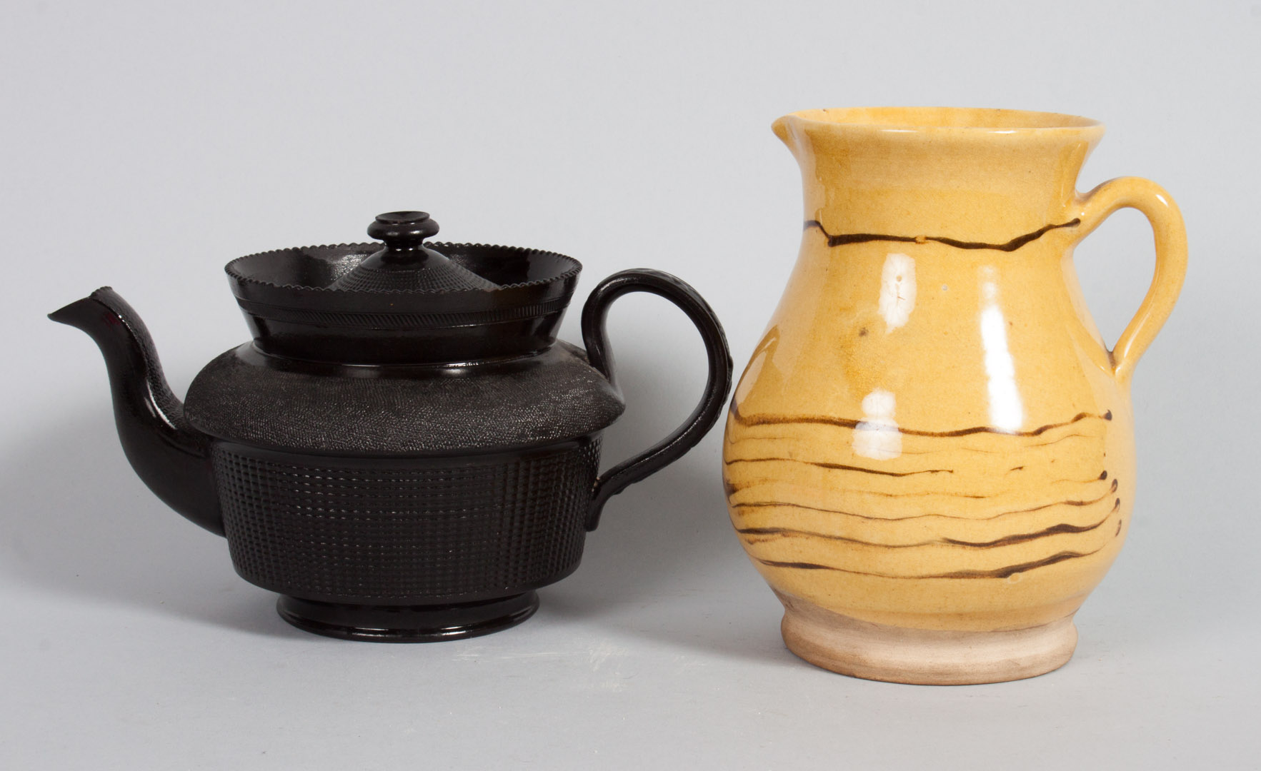 Appraisal: Staffordshire basalt teapot and yellowware jug th century glazed basalt