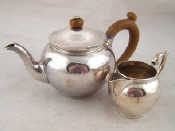 Appraisal: A silver bachelor's teapot and cream jug London Wt g