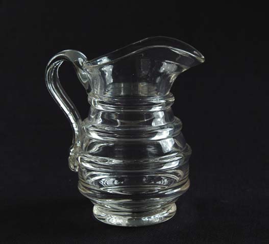 Appraisal: CLEAR FLINT GLASS RING PITCHER Applied handle four thick ring